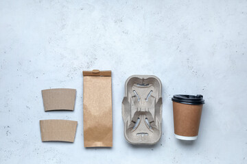 Blank bag and takeaway coffee cup on light background
