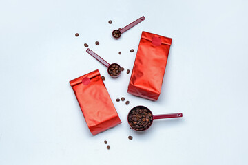 Composition with coffee bags and beans on white background