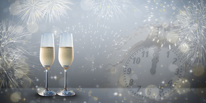 New Years eve concept with two glasses of bubbly champagne on a silver grey colored design background.
