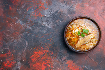 top view homemade chicken and rice soup at the right of dark background with copy space
