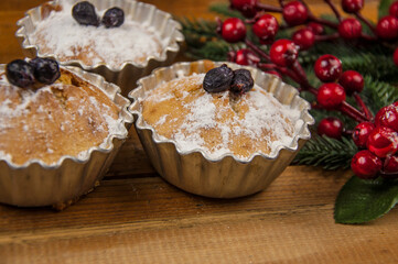 christmas decorated cupcakes on wooden background top view