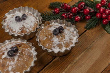 christmas decorated cupcakes on wooden background top view