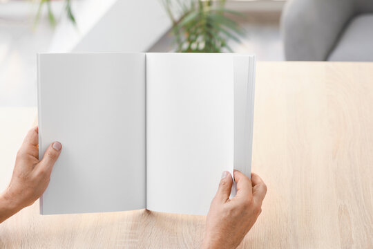 Old Man With Blank Magazine At Home