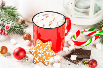 Christmas drink. Hot chocolate with marshmallow and gingerbread cookies and holiday decorations at white table.