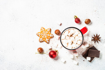Christmas drink. Hot chocolate with marshmallow and gingerbread cookies with holiday decorations at white table. Top view with copy space.