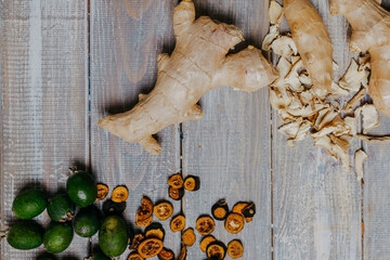 Fruit chips with fresh fruits on the wooden table. Chips for fruit leather top view. Healthy food. Oranges fruit chips. Ginger and feijoa chips.