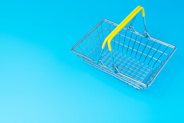 Shopping basket on blue background. Shopping concept.