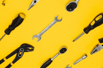 Set of various construction tools. Tools for home repair. Work at a construction site. On a yellow background. Flatly. Flatlay.