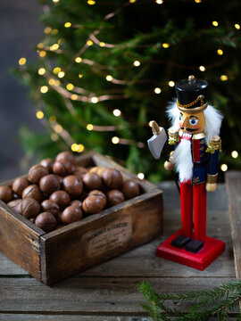 Nutcracker Christmas toy with nuts on Christmas Tree  background