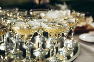 many glasses of champagne waiter pours