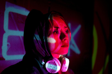 Colorful portrait of a club party woman with multicolored dynamic projector lighting.