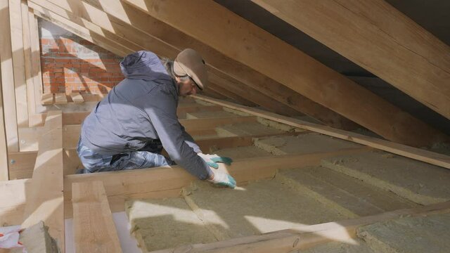 Construction work. Installation of insulation using.