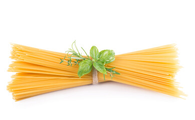Raw tagliatelle pasta and basil isolated on white background.