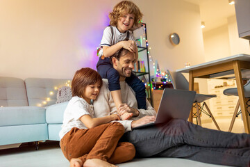 Young father trying to work from home with his kids
