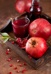 pomegranate juice and pomegranate fruit on wooden background