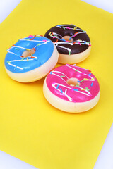 Colored donuts isolated on a yellow background