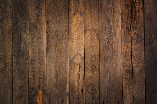 Rustic weathered wooden background. Center light area. Textured backdrop.