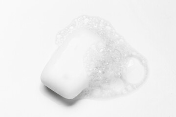 Soap bar and foam on white background, top view. Mockup for design