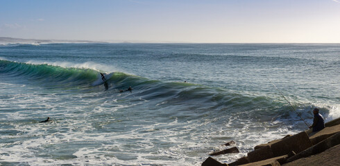 Obraz premium surfer enjoying a surf session at Sao Torpes Beach in Sines on the Alentejo Coast