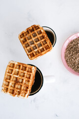 Sweet Belgian waffles on a cup of tea.