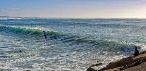 Obraz premium surfer enjoying a surf session at Sao Torpes Beach in Sines on the Alentejo Coast