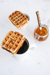 Obraz na płótnie Canvas Sweet Belgian waffles on a cup of tea.