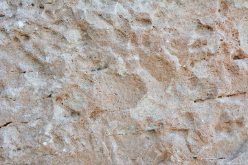Textured stone, sandstone, limestone surface. Close image. Stone, natural abstract texture for backgrounds. Close up. Wallpaper, architecture.