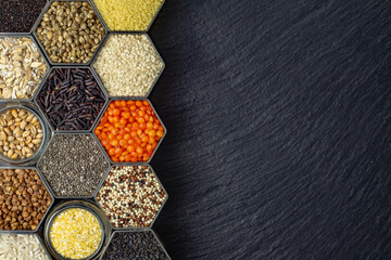 Food background of various cereals and grains in hexagonal shaped honeycomb jars