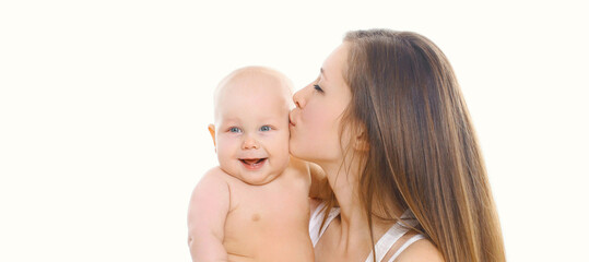 Portrait of happy mother kissing her baby over a white background