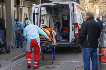 Healthcare workers transferring covid-19 patient