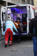 Healthcare workers transferring covid-19 patient