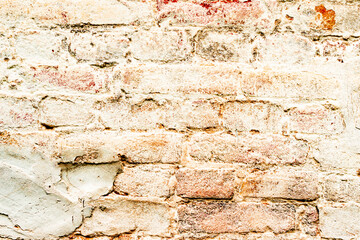Texture of a brick wall with cracks and scratches which can be used as a background