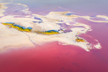 aerial view to sand islands in pink salt lake in summer day