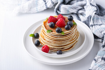 Traditional Russian pancakes with berries. Maslenitsa week. Pancake week.