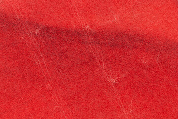 Texture of the crumpled surface of red paper. Empty background.