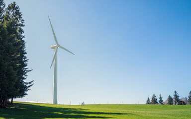 Windmill on a hill with blue sky
