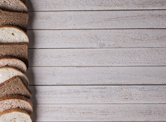 Obraz na płótnie Canvas sliced loaf of bread. white and black bread. bread on white wood background 