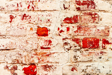 Texture of a brick wall with cracks and scratches which can be used as a background