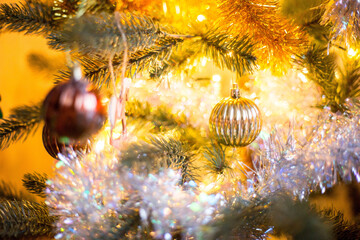 Christmas decoration on a tree, gold ball with boke around.