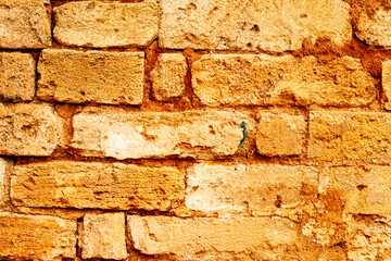 Texture of a brick wall with cracks and scratches which can be used as a background