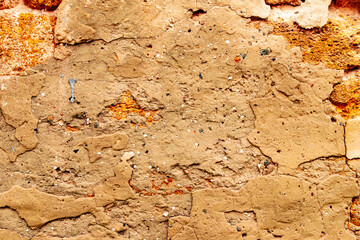 Texture of a brick wall with cracks and scratches which can be used as a background