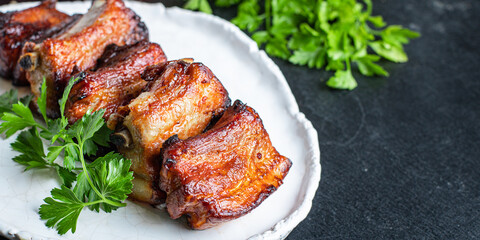 ribs meat pieces on the bone and lard fat grilled BBQ sauce second course snack ready to eat on the table meal top view copy space for text food background rustic image