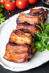 ribs meat pieces on the bone and lard fat grilled BBQ sauce second course snack ready to eat on the table meal top view copy space for text food background rustic image