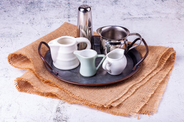 Three portion jugs for cream or milk on vintage metal tray