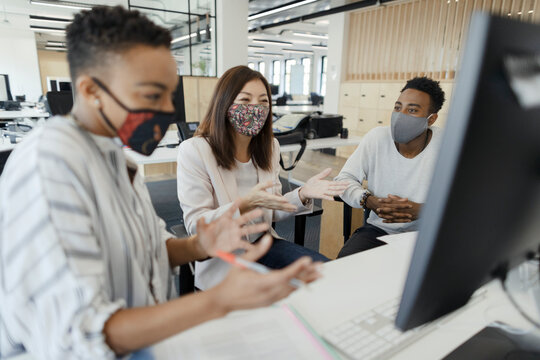 Business People In Face Masks Video Conferencing At Office Computer