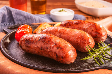 Pork sausage roasted in an iron frying pan - Close up