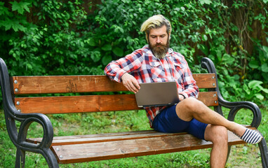 start video conferencing. communication by video call. businessman with laptop sitting on bench at park. Handsome man working on his laptop. business man working outdoors with computer. Studying hard