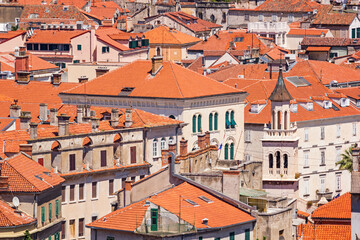 Fototapeta na wymiar Summer mediterranean cityscape with a top view of the roofs and streets of the Old Town of Split, the Adriatic coast of Croatia