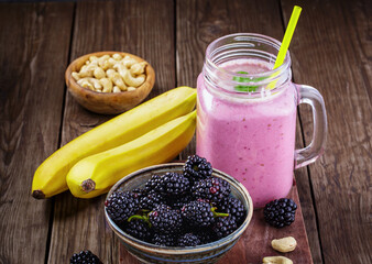 Smoothie with blackberry, banana and cashew on table