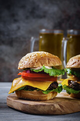 Homemade hamburger close-up with beer on table